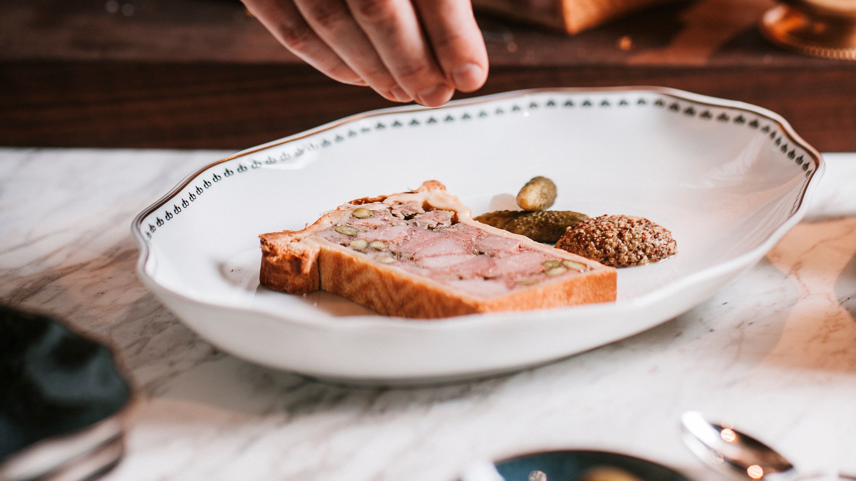 A chef plating a dish at a rooftop restaurant in  Vienna.